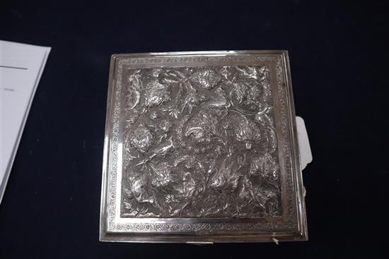 A Far Eastern white metal square box with embossed decoration of cranes and flowers